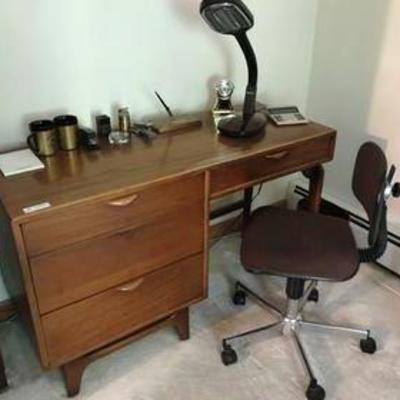 Mid-century teak desk with items on and in the desk