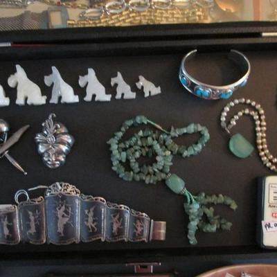 Jade carvings, necklaces and exotic silver brooches