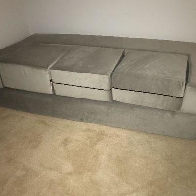 Origami futon, never used.  Can be set up as a high twin (as pictured), a low king, or a couch with ottomans.  $200