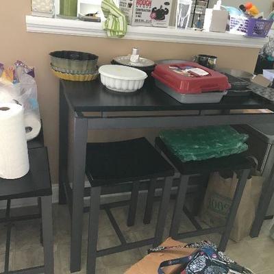 Long high top table with 4 stools.  Various kitchen and baking items available.