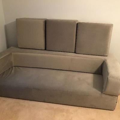Origami futon, never used.  Can be set up as a high twin, a low king, or a couch (as pictured) and additional pieces can be used as...