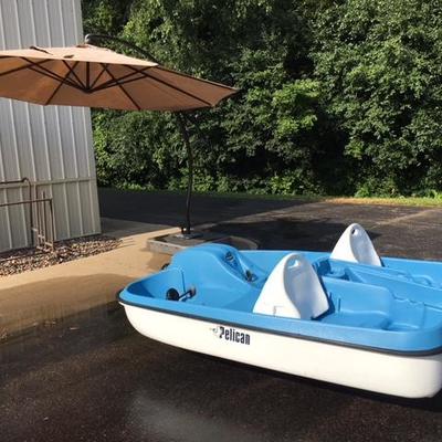 Free standing and movable umbrella and 5 person pedal boat.