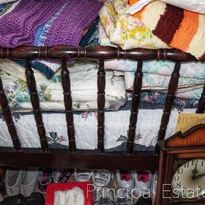 Antique spindle bed, afghans and blankets