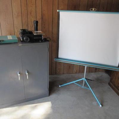 Kodak slide projector, pull up screen and metal cabinet with doors