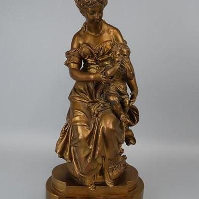 Bronze statue featuring a woman holding her child