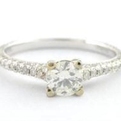 Sterling silver ring with large center diamond accompanied by smaller accent diamonds