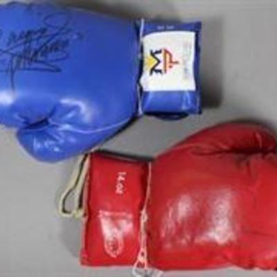 A Manny Pacquiao autographed blue Team Pacquiao boxing glove (20 oz) | Pac Man signed the back of the glove with a black marker. His...