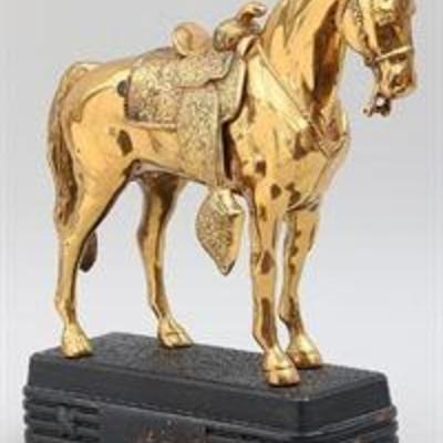 Abbotwares gilt metal horse with removeable saddle on metal base. Lacking reins, gilt loss. 12-1/2''h, 14''l, 5''w 