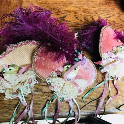 Katherine's Collection. Christmas ornaments. Feline with had and feather, plus tassels. $18 each.