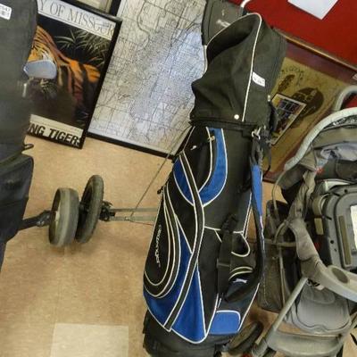 Bag boy golf caddy with golf clubs.