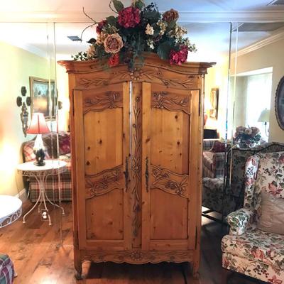 Beautiful carved pine storage armoire measures 44