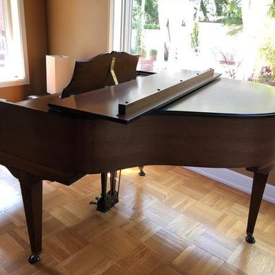 Howard Baby Grand Piano - plays nice and is all wrapped up and ready to be moved to your home!