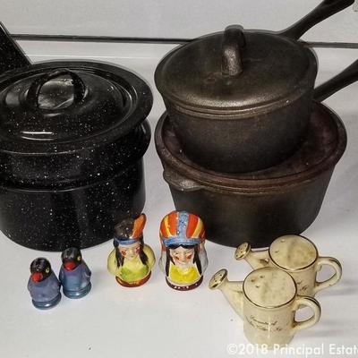 Vintage enamel double boiler, cast iron pots with lids, salt and pepper shaker sets 

