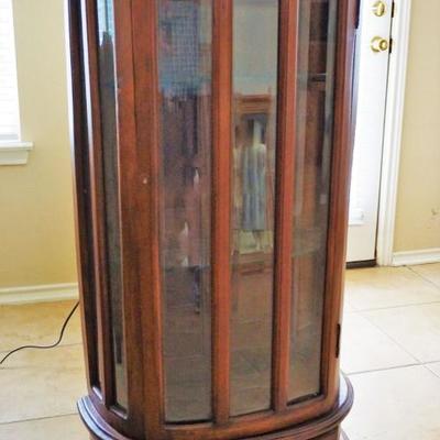 Small Mahogany Curved beveled and leaded glass paneled Mahogany curio cabinet. Qulaity well made reproduction, very utilitarian piece....