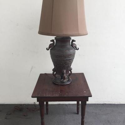 Asian motif metal lamp and wood table