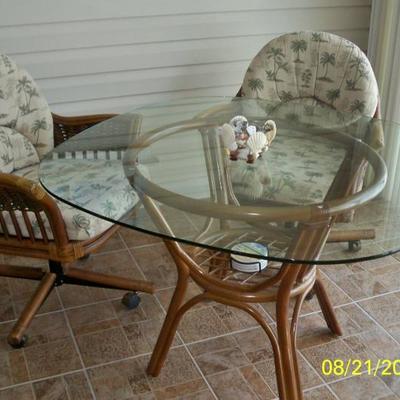 Rattan and Glass table with 4 chairs ( 2 shown)