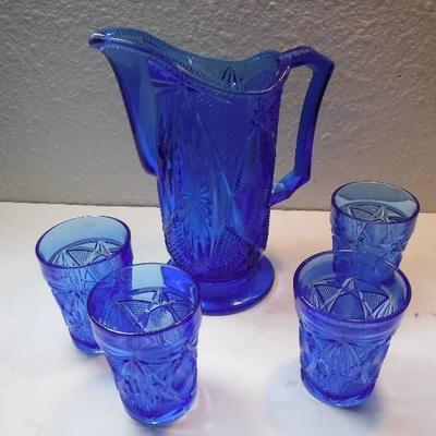 antique blue glass pitcher with glasses