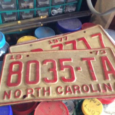WE HAVE VINTAGE LICENSE PLATES ALL OVER THE PLACE