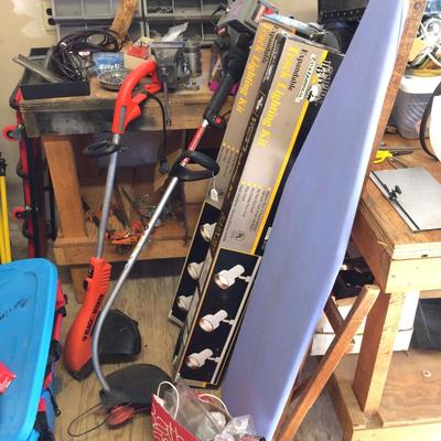 Track lighting, multiple ironing boards, and an electric and gas powered Weedwhacker.