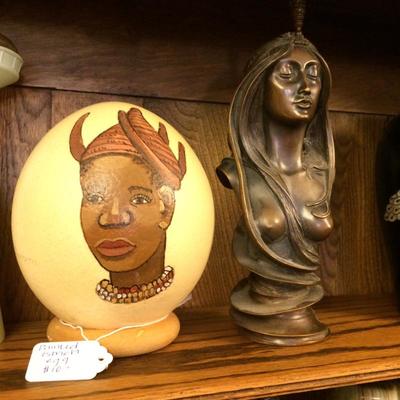 Painted ostrich egg from Africa next to bronze bust by Alfons Mucha.