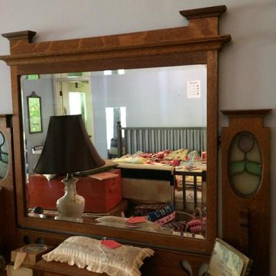 Close up of oak vanity mirror with Stainglass decoration.