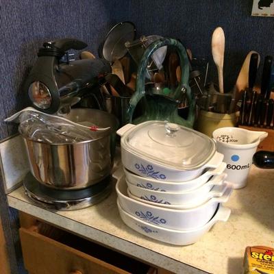 Ceramic leftover containers and a broad assortment of kitchen tools.