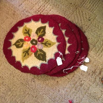 Four vintage antique book rugs, approximately 12" in diameter.