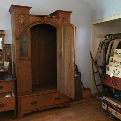 Arts & crafts wardrobe with door open.