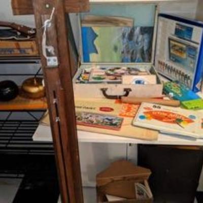 Nice old artists easel along with paint and artist accessories.