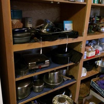 Cookware including cast-iron, vintage cookware, and other miscellaneous kitchen items.