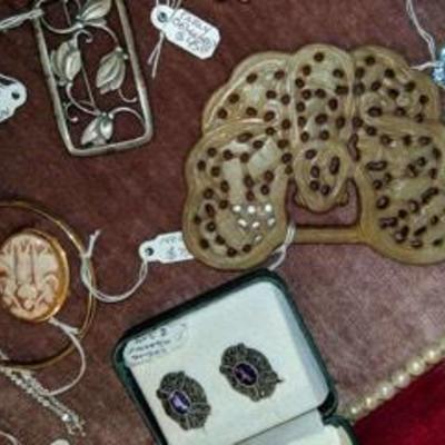 Find jewelry, including: carved cameo pin set in 14K gold, and a nephrite Jade belt buckle, etc.