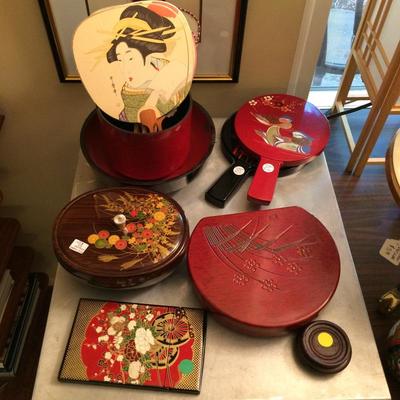 Japanese lacquerware items along with hand-painted silk fans.