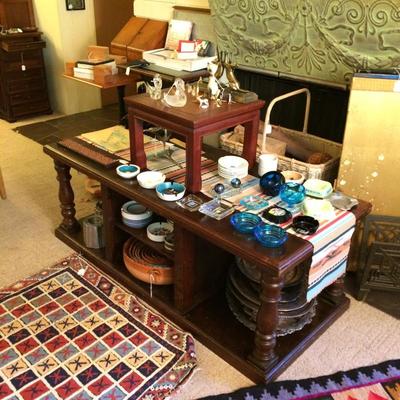 Large handmade mahogany coffee table with ash trays on top of it.
