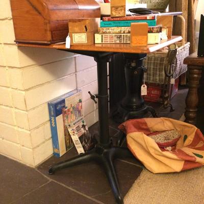 Utilitarian table with cast iron base and golden oak table top.