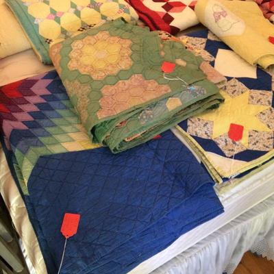 Bright colored vintage quilts in good condition.