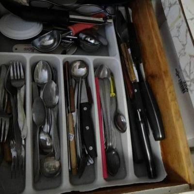 3 small drawers with silverware and kitchen utensi