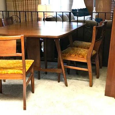 Mid Century Dining Table with 3 leaves and 8 Chairs. Wood on table and chairs is in very nice condition. The chairs could use new fabric...