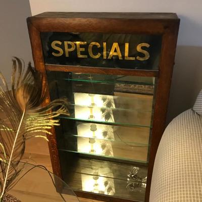 Display Cabinet made with vintage door. The cabinet is lit, mounts to the wall and has 4 adjustable glass shelves.