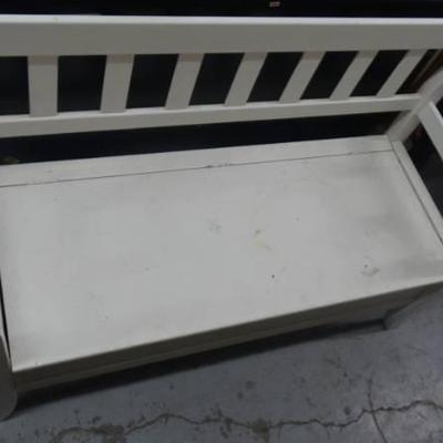 Bench with storage space filled with a variety of ...