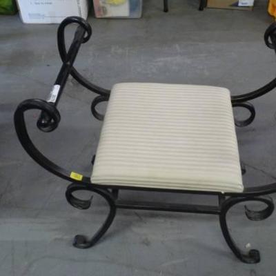 Metal bench with padded seat.