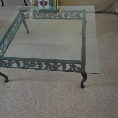 Glass top coffee table with metal base.