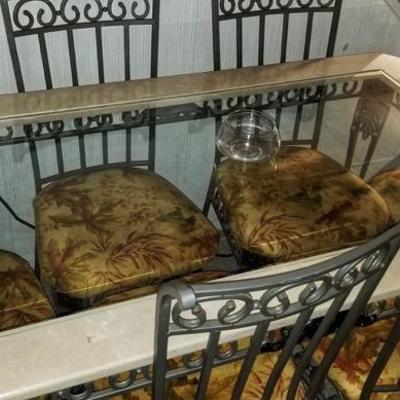 Seriously heavy wrought iron dining table set with 6 matching chairs and glass top