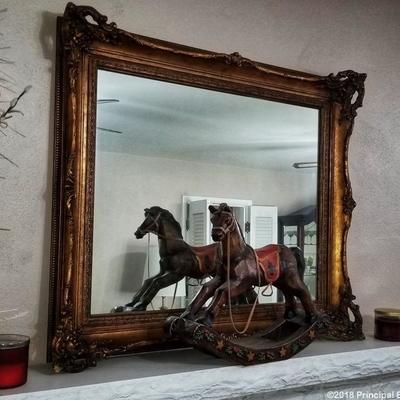 Carousel style wood rocking horse.  Gold gilded mirror