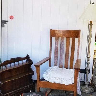 Antique rocking chair, needlepoint foot rest, floor lamp