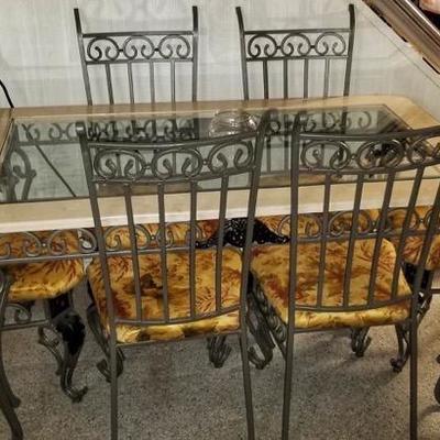 Seriously heavy wrought iron dining table set with 6 matching chairs and glass top