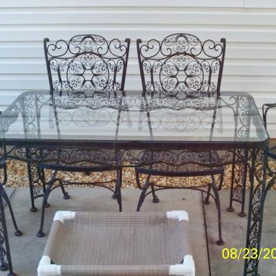 Wrought Iron Patio table with glass top and 4 chairs