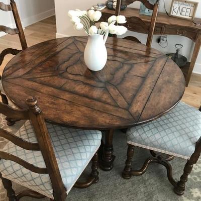 Custom made dining table and 4 chairs. Table is round with drop leaves to make it square. Originally purchased for $10,000. Estate sale...