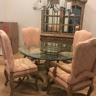 Custom made dining table and chairs. Two are captain's chairs and 2 without arms. Glass weighs A LOT. Originally purchased for $6,000....