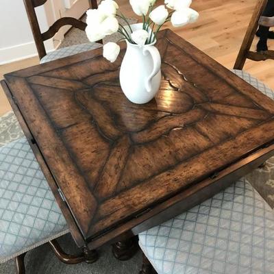 Custom made dining table and 4 chairs. Table is round with drop leaves to make it square. Originally purchased for $10,000. Estate sale...