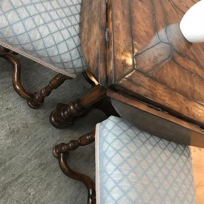 Custom made dining table and 4 chairs. Table is round with drop leaves to make it square. Originally purchased for $10,000. Estate sale...